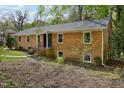 Charming brick home featuring a well-maintained yard and classic architectural details at 4815 Oak Park Rd, Raleigh, NC 27612