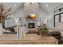 Bright living room featuring a stone fireplace, hardwood floors, and stylish decor at 482 Emily Ln, Chapel Hill, NC 27516