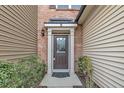 Welcoming front entrance featuring a classic door, covered porch, and neatly trimmed shrubs at 520 Brier Crossings Loop, Durham, NC 27703