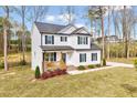 Attractive two-story home with a landscaped yard and inviting front porch at 62 Narmada Ct, Zebulon, NC 27597