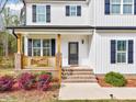 Inviting front porch with brick steps and decorative landscaping at 62 Narmada Ct, Zebulon, NC 27597