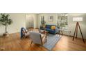 Bright living room featuring hardwood floors, a cozy sofa, and ample natural light at 704 Emory Dr, Chapel Hill, NC 27517