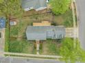 Overhead shot shows house with a deck and tidy yard, capturing its peaceful setting on a well-maintained street at 8000 Old Deer Trl, Raleigh, NC 27615