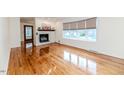 Spacious living room featuring gleaming hardwood floors, a fireplace, and large windows at 808 N Franklin Dr, Sanford, NC 27330