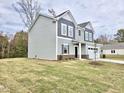 Stylish two-story home with gray siding, a well-manicured lawn, and a two-car garage at 829 Kenyon Spring Dr, Zebulon, NC 27597
