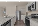 Modern kitchen with granite countertops, stainless steel appliances, and ample cabinet space at 829 Kenyon Spring Dr, Zebulon, NC 27597