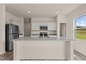 Modern kitchen featuring granite countertops, stainless steel appliances, and an island at 829 Kenyon Spring Dr, Zebulon, NC 27597