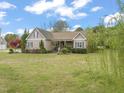 Attractive single-Gathering home with lush landscaping and a welcoming front porch at 8437 Little Woody Ct, Zebulon, NC 27597