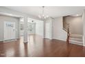 Bright dining area with an open floor plan leading to the living room and a stairway with wood trim at 912 Ambergate Sta, Apex, NC 27502