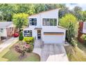 Lovely two-story home with modern design, striking windows, and a well-manicured lawn and garden at 915 S State St, Raleigh, NC 27601