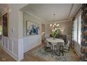 Bright dining room boasts stylish decor, wainscoting, and ample natural light, perfect for Gathering meals at 97 August Trace Dr, Pittsboro, NC 27312