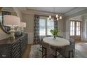 Bright dining room boasts stylish decor, wainscoting, and ample natural light, perfect for Gathering meals at 97 August Trace Dr, Pittsboro, NC 27312