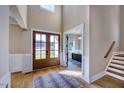 Welcoming foyer with hardwood floors, soaring ceilings, and elegant glass front door, offering a grand entrance at 97 August Trace Dr, Pittsboro, NC 27312