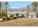 Inviting two-story home with attached two-car garage, manicured front lawn and flower boxes at 104 Perth Ct, Cary, NC 27511