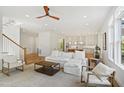 Open living area showcasing hardwood floors, modern furnishings, and seamless flow into the bright, stylish kitchen at 1200 Roosevelt Dr, Chapel Hill, NC 27514
