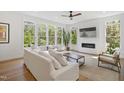 Sunlit living room with a modern fireplace, large windows, and comfortable seating, creating a relaxing atmosphere at 1200 Roosevelt Dr, Chapel Hill, NC 27514
