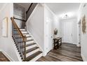 Elegant staircase with wood treads, white risers, and dark railing at 139 Pronghorn Deer Ct, Garner, NC 27529
