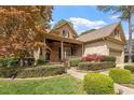 Beautiful brick and stone home with a covered front porch, lush landscaping, and mature trees at 1525 Marshall Farm St, Wake Forest, NC 27587
