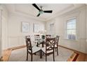 Elegant dining room featuring natural light, tray ceilings, and a glass-topped table with seating at 21 W Paige Wynd Dr, Angier, NC 27501
