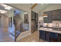 Bright kitchen with stainless steel appliances, a marble island with seating, and an open staircase nearby at 2108 New Hope Church Rd, Chapel Hill, NC 27514