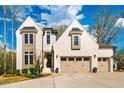 Charming two-story home featuring a light brick facade and attached two-car garage at 215 Bonterra Way, Chapel Hill, NC 27516