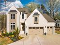 Charming two-story home boasts a manicured lawn, three-car garage, and inviting curb appeal at 215 Bonterra Way, Chapel Hill, NC 27516