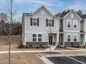 Charming two-story townhome with stone accents and manicured landscaping offers great curb appeal at 2456 Tonoloway Dr, Raleigh, NC 27610