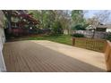 Large wooden deck overlooking the fenced backyard, perfect for entertaining and relaxation at 2704 Pidgeon Hill Rd, Raleigh, NC 27613