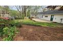 Spacious backyard with a wooden deck and green space, offering privacy and outdoor enjoyment at 2704 Pidgeon Hill Rd, Raleigh, NC 27613