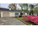 View of the exterior of a home with beautiful landscaping and a paved driveway at 2704 Pidgeon Hill Rd, Raleigh, NC 27613
