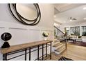 Elegant entryway featuring wood floors, decorative mirror, and views into the living space at 285 Gilliland Rd, Siler City, NC 27344