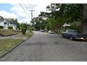 A street view showcasing the quiet neighborhood and mature trees lining the street at 301 Dunstan Ave, Durham, NC 27707