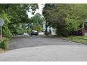 The street view displays a quiet neighborhood with mature trees and other homes in the background at 301 Dunstan Ave, Durham, NC 27707