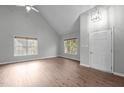 Bright living room featuring vaulted ceilings, hardwood floors, and natural light from large windows at 301 Tillamook Dr, Wake Forest, NC 27587