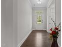 Entryway boasts gleaming hardwood floors, white trim, and a glass paneled front door allowing ample light at 3020 Mavisbank Cir, Apex, NC 27502