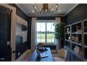 Elegant office features custom shelving, hardwood floors, and a large window with a view at 303 Gilliland Rd, Siler City, NC 27344