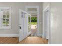 Bright entryway featuring hardwood floors, a glass paneled door, and neutral paint tones at 308 Charles St, Henderson, NC 27536