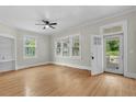 Inviting living room with hardwood floors, large windows, ceiling fan, and a bright, airy ambiance at 308 Charles St, Henderson, NC 27536