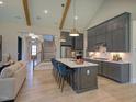 Open-concept kitchen with a large island, stainless appliances, and a view of the staircase at 321 Gilliland Rd, Siler City, NC 27344