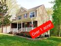 Beautiful two-story home on over one acre featuring a spacious yard and inviting front porch at 3729 Norman Blalock Rd, Willow Springs, NC 27592