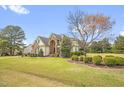 Well-maintained home with a lush green lawn, mature trees, and manicured shrubbery at 432 Kings Hollow Dr, Raleigh, NC 27603