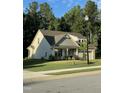 A two story home with stone accents and two car garage sits on a well manicured lawn at 53 Azul Dr, Clayton, NC 27520