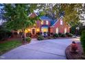 Beautiful two story brick home with manicured landscaping and a curved driveway at 702 Orange Dr, Elon, NC 27244
