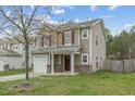 Charming two-story home with an attached single-car garage and a well-kept lawn at 707 Obsidian Way, Durham, NC 27703