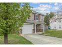 Charming two-story home with an attached single-car garage and a well-kept lawn at 707 Obsidian Way, Durham, NC 27703