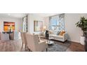 Bright, open-concept living room featuring modern decor, large windows, and seamless access to the dining area at 712 Holstein Dairy Way, Wake Forest, NC 27587