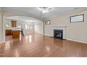 Cozy living room featuring a fireplace, hardwood floors, and an archway leading to the kitchen at 814 Ember Dr, Durham, NC 27703