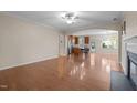 Bright, open-concept living room with gleaming hardwood floors and an arched entryway at 814 Ember Dr, Durham, NC 27703
