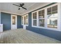 Covered back porch featuring a ceiling fan and natural wood flooring, perfect for outdoor relaxation at 818 St Charles St, Durham, NC 27713