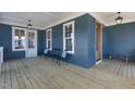 Cozy back porch with blue siding, a wooden bench, and outdoor seating for enjoying the outdoors at 818 St Charles St, Durham, NC 27713
